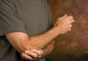 Image of chiropractic patient with tennis elbow pain.